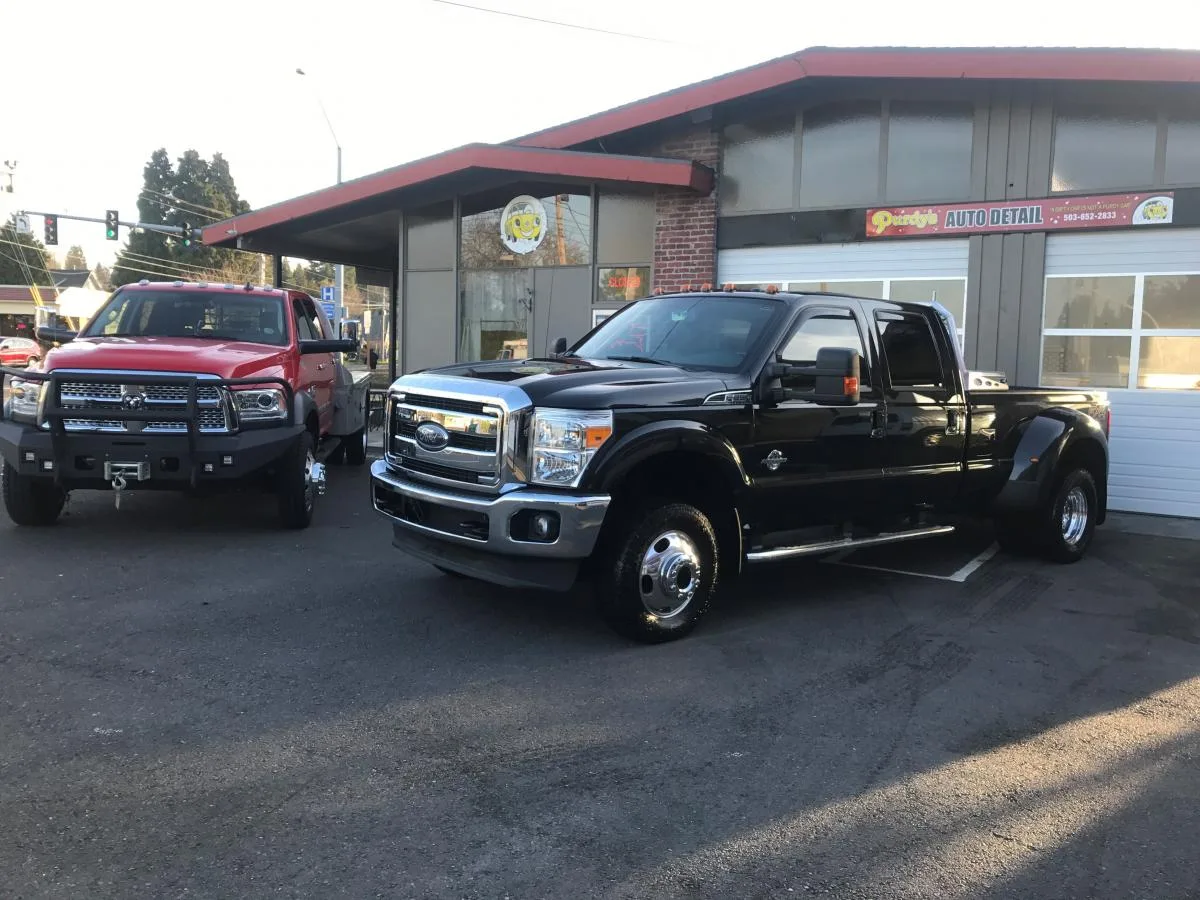 Freshly detailed black truck outside Purdy's Auto Detail